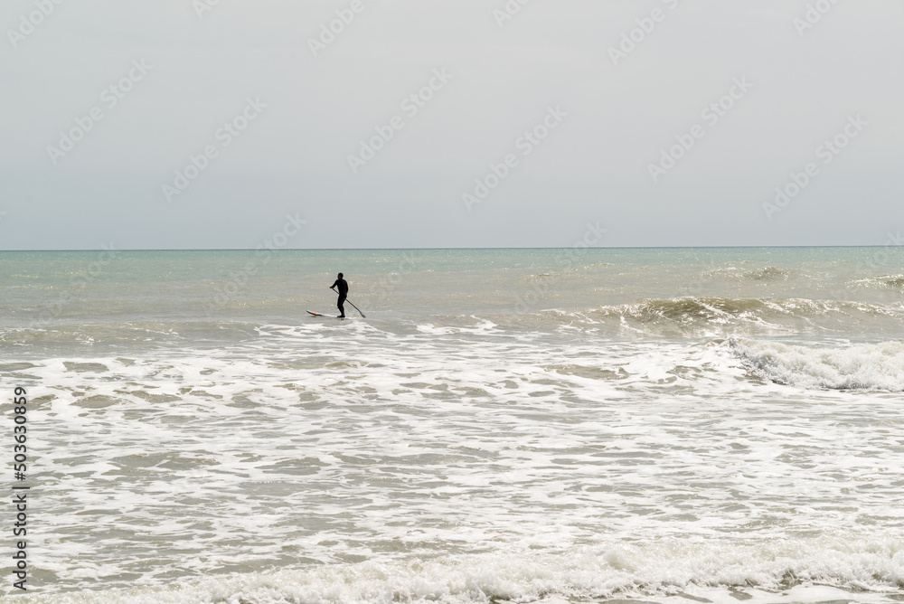 Silhouette of a man practising paddle surf. Silhouette of a man practising paddle surf.