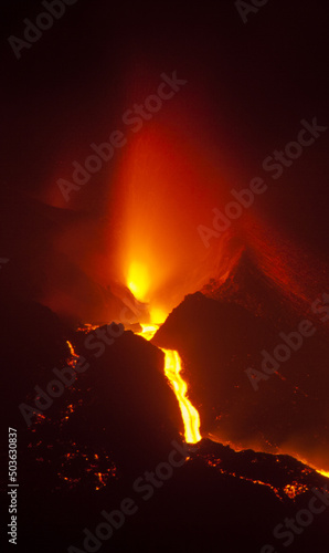 Lava flow down by the crater of volcano. photo