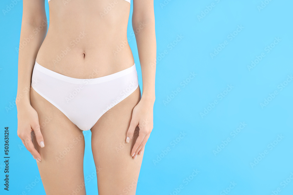 Concept of weight loss, young woman body on blue background Concept of weight loss, young woman body on blue background