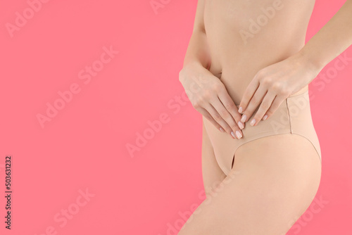Concept of weight loss, young woman body on pink background