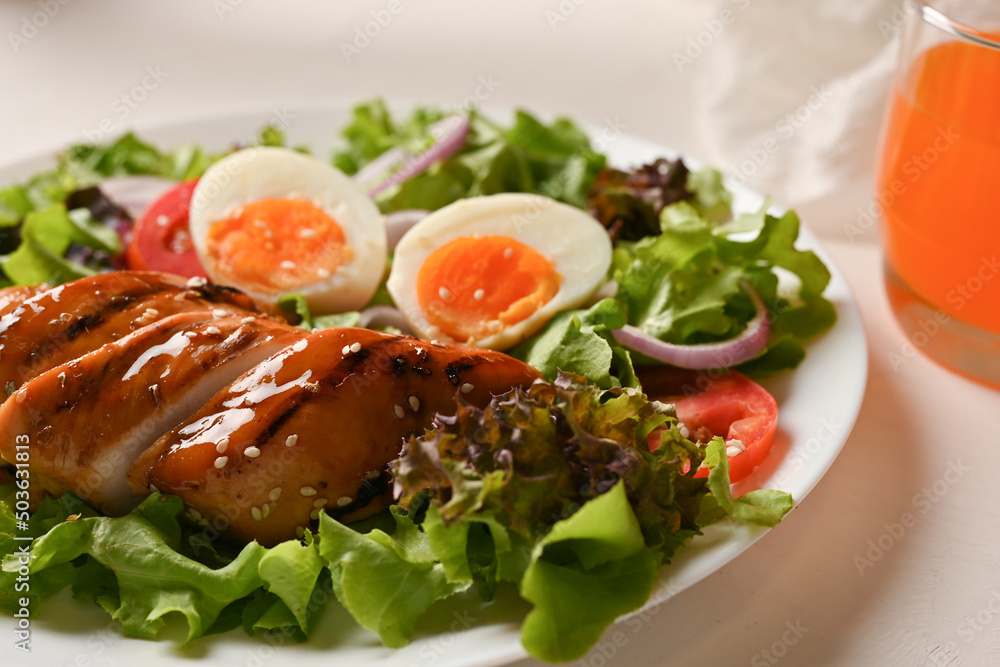 Grilled teriyaki chicken breast with boiled eggs and fresh organic salad mix.