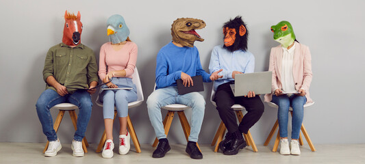 Funny people with animal faces talking while sitting in row in waiting room. Company employees or job applicants in silly masks sitting in line, chatting, using laptops, reading and discussing news