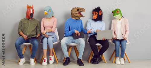 Fotografie Funny people with animal faces talking while sitting in row in waiting room