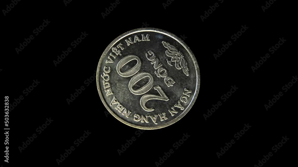 Rotating reverse of Vietnam coin 200 dongs 2003 with inscription meaning NATIONAL BANK OF VIETNAM. Isolated in black background. Rotating reverse of Vietnam coin 200 dongs 2003 with inscription meaning NATIONAL BANK OF VIETNAM. Isolated in black background.