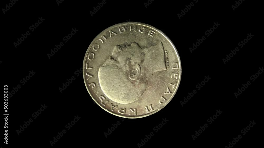 Rotating obverse of Yugoslavia coin 50 dinara 1938 with inscription meaning PETAR II THE KING OF YUGOSLAVIA. Isolated in black background. Rotating obverse of Yugoslavia coin 50 dinara 1938 with inscription meaning PETAR II THE KING OF YUGOSLAVIA. Isolated in black background.