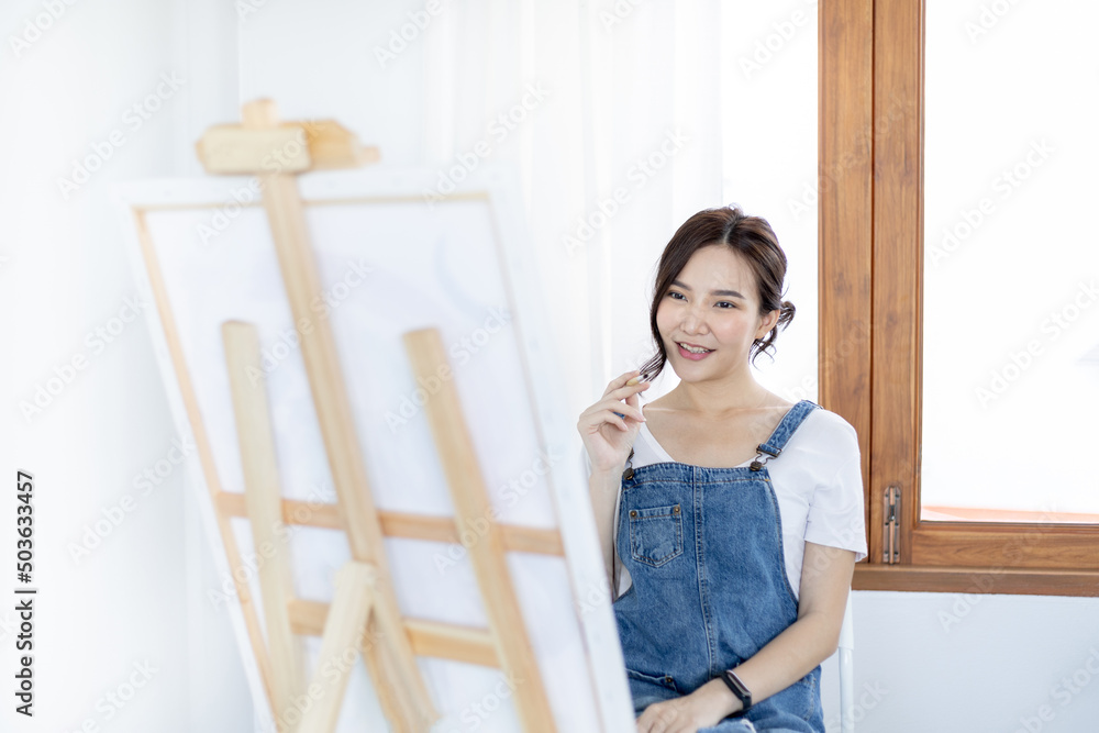 Female artist painting on canvas, Artist studio interior, Draw with watercolor, Drawing supplies , Painting and creativity, Use a brush to draw a pattern by stripes, Artwork, Using Paint Brush. Female artist painting on canvas, Artist studio interior, Draw with watercolor, Drawing supplies , Painting and creativity, Use a brush to draw a pattern by stripes, Artwork, Using Paint Brush.