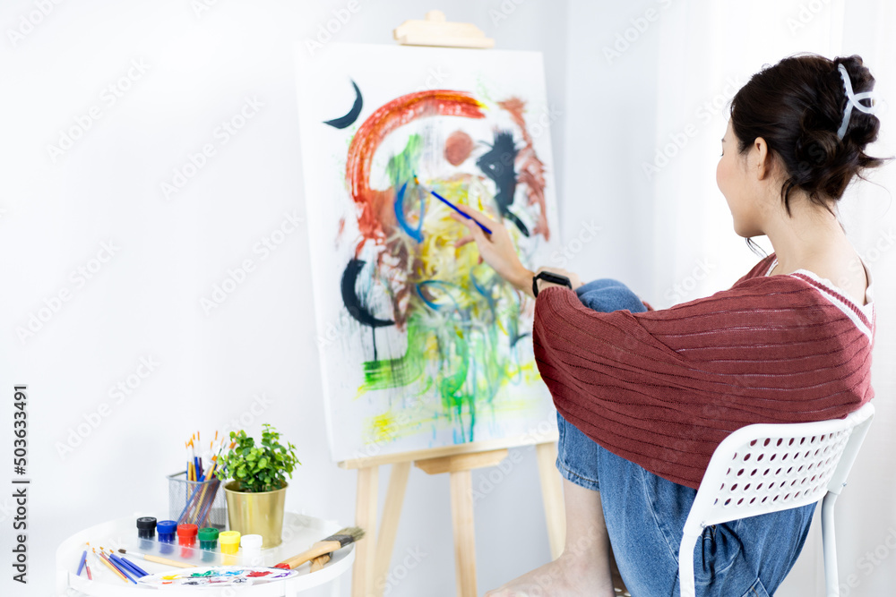 Female artist painting on canvas, Artist studio interior, Draw with watercolor, Drawing supplies , Painting and creativity, Use a brush to draw a pattern by stripes, Artwork, Using Paint Brush. Female artist painting on canvas, Artist studio interior, Draw with watercolor, Drawing supplies , Painting and creativity, Use a brush to draw a pattern by stripes, Artwork, Using Paint Brush.