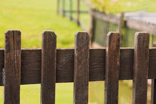 Old wooden fence in park, closeup view