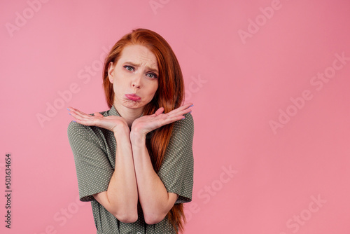 redhair ginger woman disappointed looking studio background