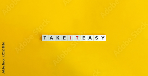Obraz na plátně Take It Easy Idiom on Letter Tiles on Yellow Background