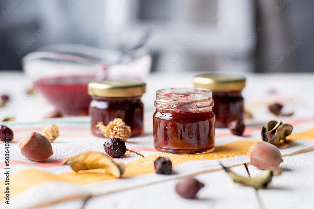 raspberry jam on the table. a jar of red marmalade on a light-colored fabric raspberry jam on the table. a jar of red marmalade on a light-colored fabric