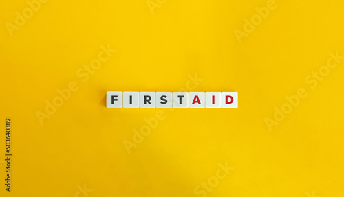 First Aid Word and Banner. Letter Tiles on Yellow Background. Minimal Aesthetics.