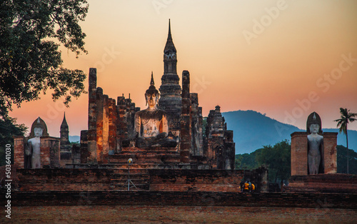 Sunset at Wat Mahathat buddha and temple in Sukhothai Historical Park © pierrick