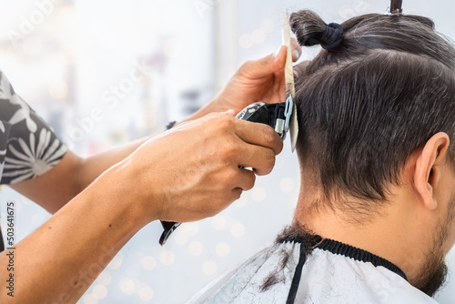 Hairdresser cuts razor in barbershop