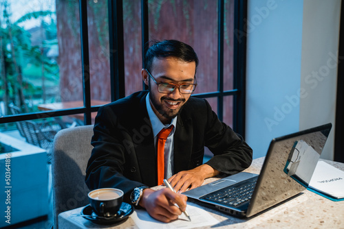 portrait of asian businessman working late at his office in the evening
