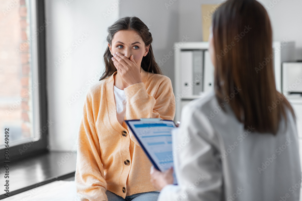 medicine, healthcare and people concept - female doctor with clipboard talking to scared or coughing woman patient at hospital medicine, healthcare and people concept - female doctor with clipboard talking to scared or coughing woman patient at hospital
