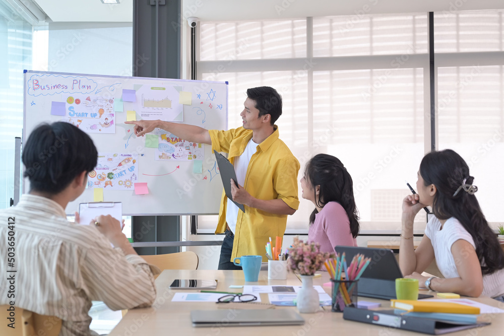 Shot of male manager giving presenting new marketing strategy on flip chart in meeting. Shot of male manager giving presenting new marketing strategy on flip chart in meeting.