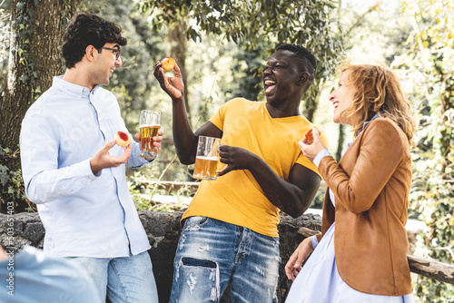 Canvas Print multiracial group of friends laughing and having fun at party, mixed age range g