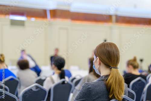 Woman watching presentation during seminar