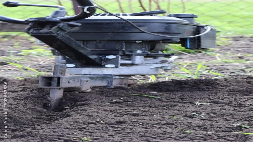 Gardener man cultivate ground soil with tiller tractor and rototiller, cultivator and prepare for planting crop in spring. High quality Full HD footage Gardener man cultivate ground soil with tiller tractor and rototiller, cultivator and prepare for planting crop in spring. High quality Full HD footage