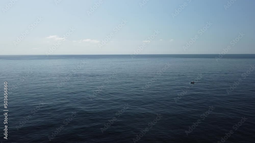 Aerial view from above on calm azure sea and volcanic rocky shores. Small waves on water surface in motion blur. Nature summer ocean sea beach background. Nobody. Holiday, vacation and travel concept Aerial view from above on calm azure sea and volcanic rocky shores. Small waves on water surface in motion blur. Nature summer ocean sea beach background. Nobody. Holiday, vacation and travel concept