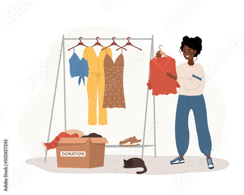 Clothes donation. African woman putting old clothes ready to be shared or recycled from wardrobe to cardboard box. Volunteering and social care. International charity day. Vector cartoon illustration.