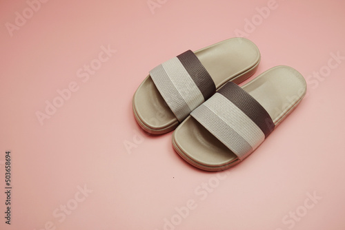 Gray slide sandal summer slippers on pink background