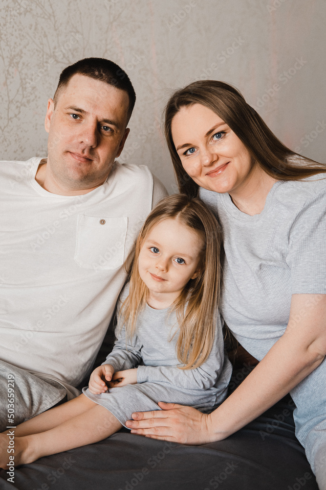 Portrait of loving family with infant daughter. Happy caucasian family of three people. Selective focus. Film grain Portrait of loving family with infant daughter. Happy caucasian family of three people. Selective focus. Film grain
