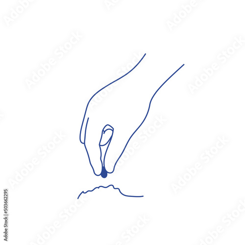 Human hand plants seed in the ground.