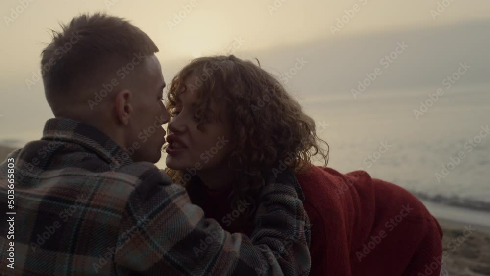 Romantic couple kissing on beach at sunrise. Girl and guy hugging each other Romantic couple kissing on beach at sunrise. Girl and guy hugging each other