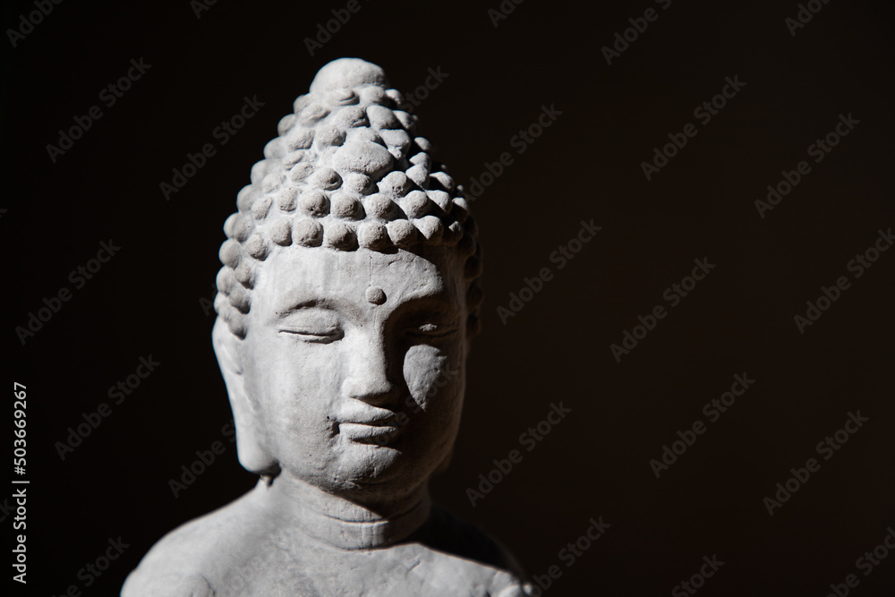 buddha face on a dark background