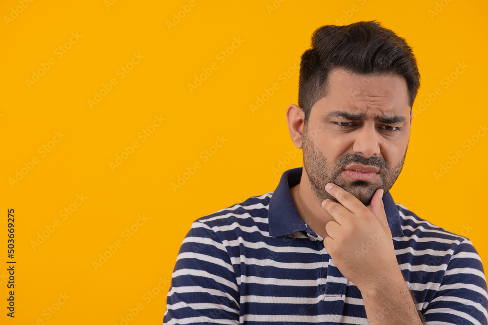 Portrait of frustrated man with hand on chin Portrait of frustrated man with hand on chin