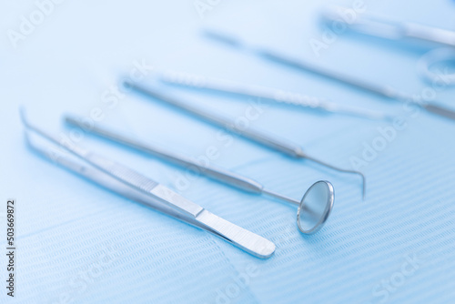 Closeup different dental instruments and tools, blue toning. Concept dentists room office