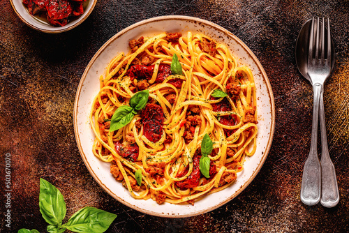 Pasta with bolognese sauce and sun-dried tomatoes photo