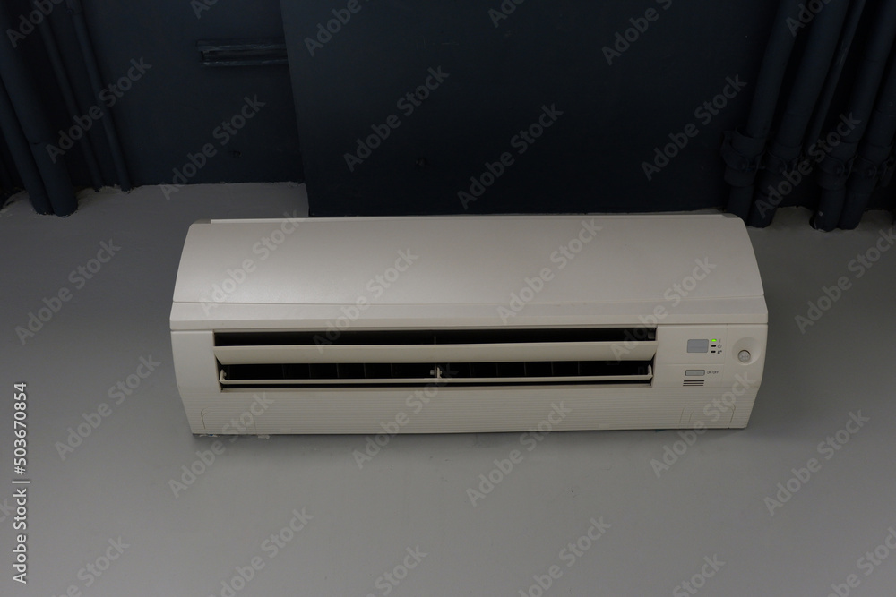 front view white wall mounted air conditioner on white and grey wall background, object, technology, decor, fashion, home, office, copy space front view white wall mounted air conditioner on white and grey wall background, object, technology, decor, fashion, home, office, copy space