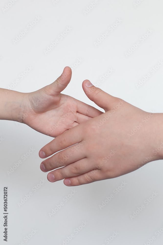 Children's hands gesticulating on a white background. Male greeting. Children's hands gesticulating on a white background. Male greeting.