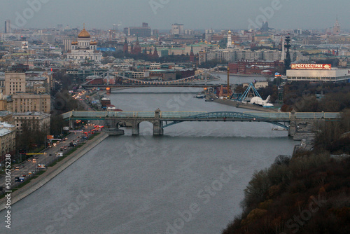 Moscow, Russia - March, 02, 2021: St. Andrew bridge on Moskva river. Cathedral of Christ the Saviour, Kremlin and Peter 1 monument. Buran space shuttle right.