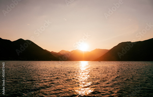Tableau sur toile Sea landscape over the blue mountain in sunset