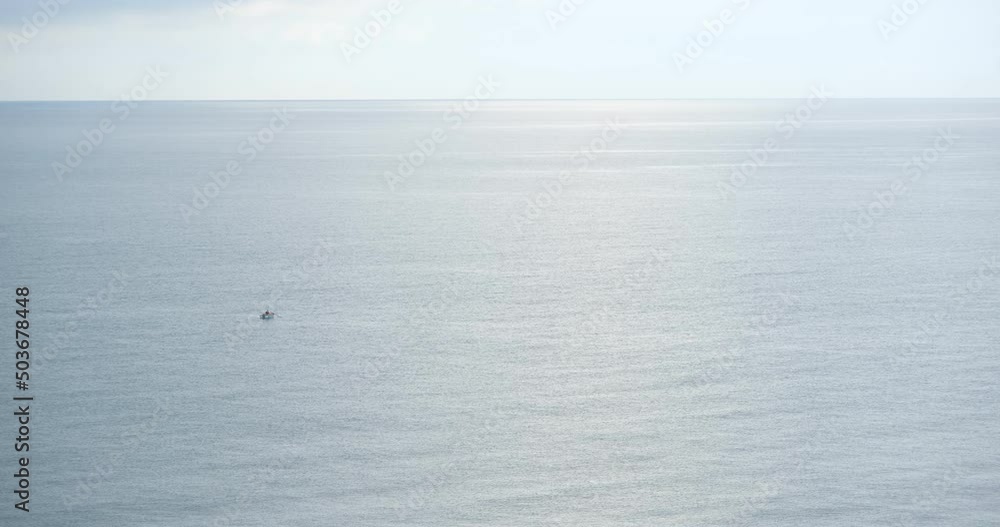 boat in the sea. Lonely fisherman fishing in calm sea water. fisherman in a small rowing boat, fishing far from the coast boat in the sea. Lonely fisherman fishing in calm sea water. fisherman in a small rowing boat, fishing far from the coast