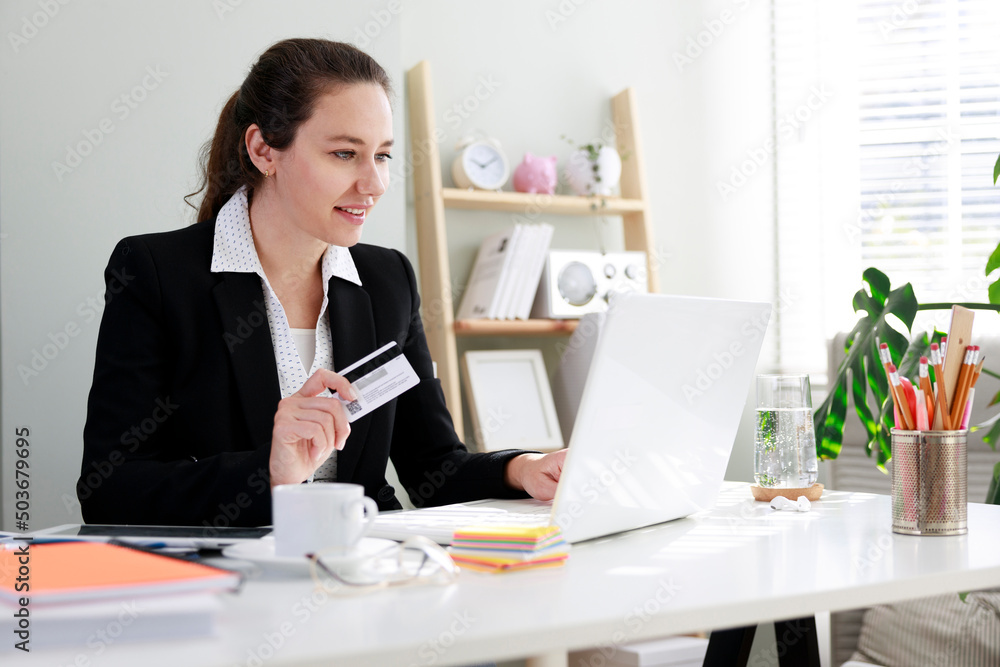 Business woman shopping online with laptop and credit card Business woman shopping online with laptop and credit card