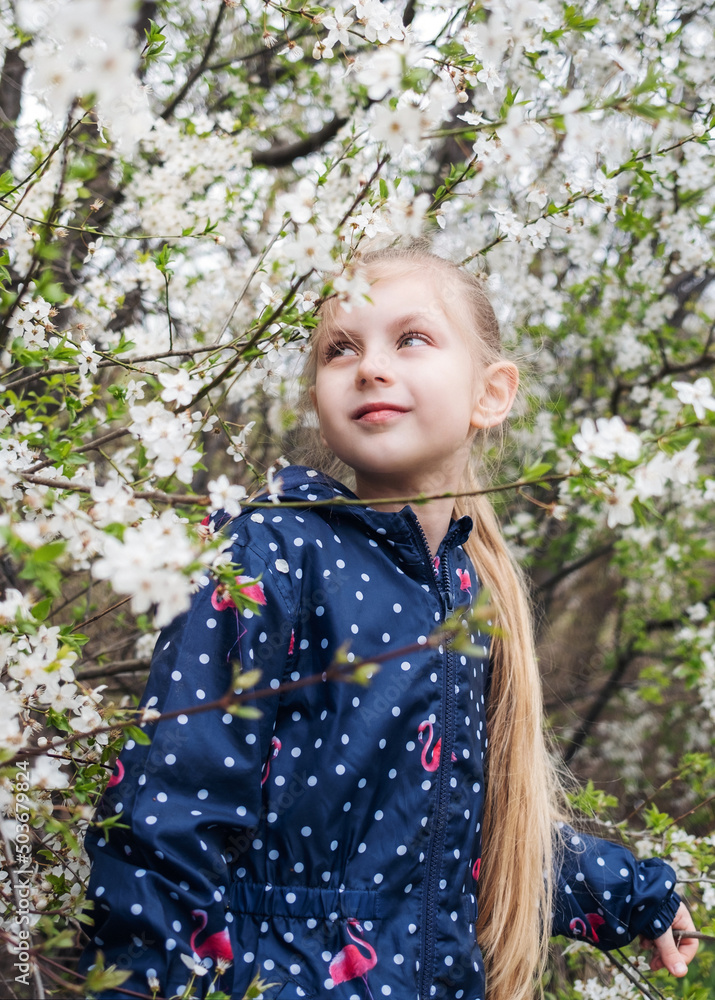 Cute little girl in a blossoming spring garden Cute little girl in a blossoming spring garden