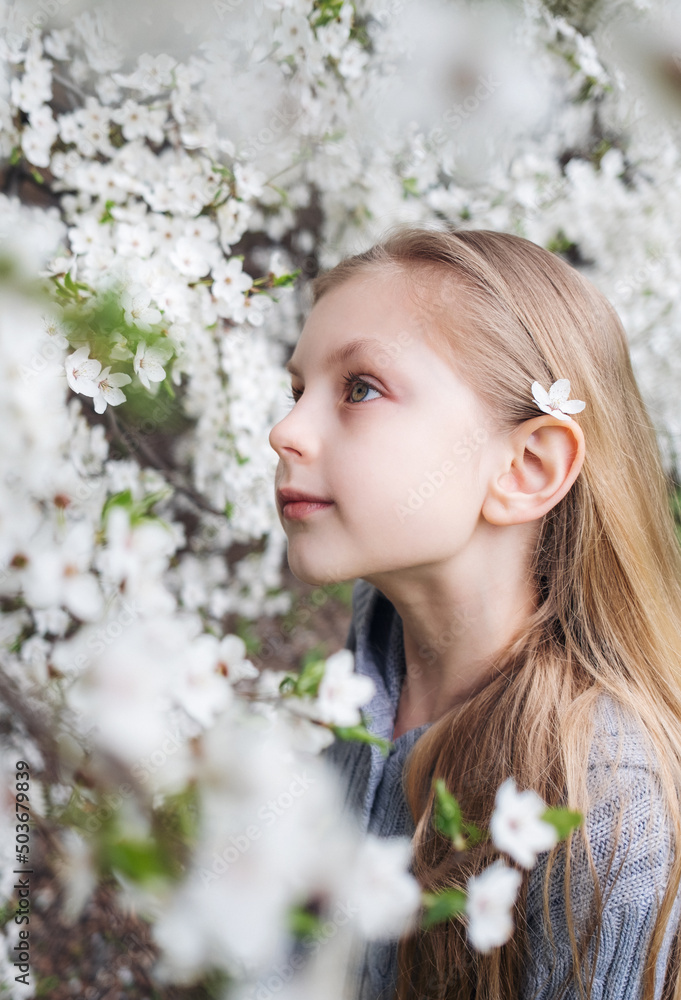 Cute little girl in a blossoming spring garden Cute little girl in a blossoming spring garden