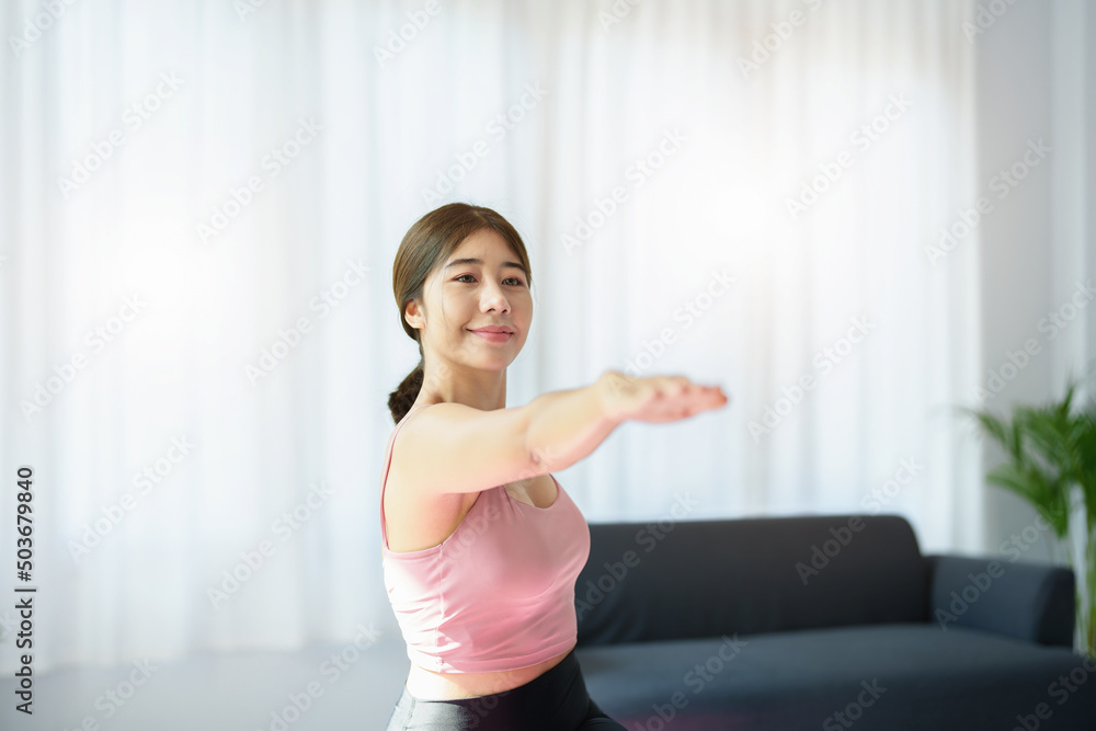 stress relief, muscle relaxation, breathing exercises, exercise, meditation, portrait of Young Asian woman relaxing her body from office work by practicing yoga by watching online tutorials. stress relief, muscle relaxation, breathing exercises, exercise, meditation, portrait of Young Asian woman relaxing her body from office work by practicing yoga by watching online tutorials.