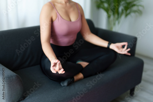 stress relief, muscle relaxation, breathing exercises, exercise, meditation, portrait of Young Asian woman relaxing her body from office work by practicing yoga by watching online tutorials.