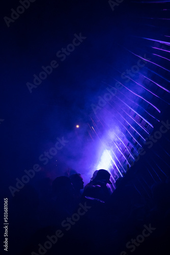 DJ's playing under lights at a night festival.