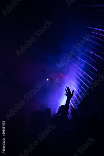 DJ's playing under lights at a night festival.