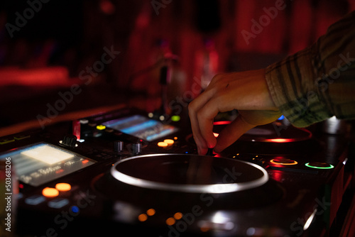 DJ's playing under lights at a night festival.