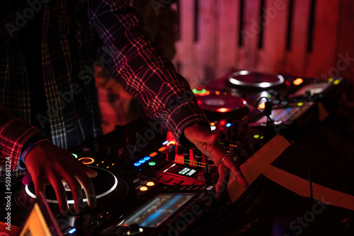 DJ's playing under lights at a night festival.