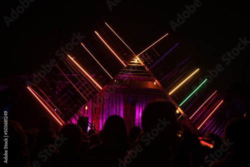 DJ's playing under lights at a night festival.
