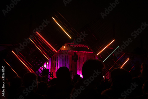DJ's playing under lights at a night festival.